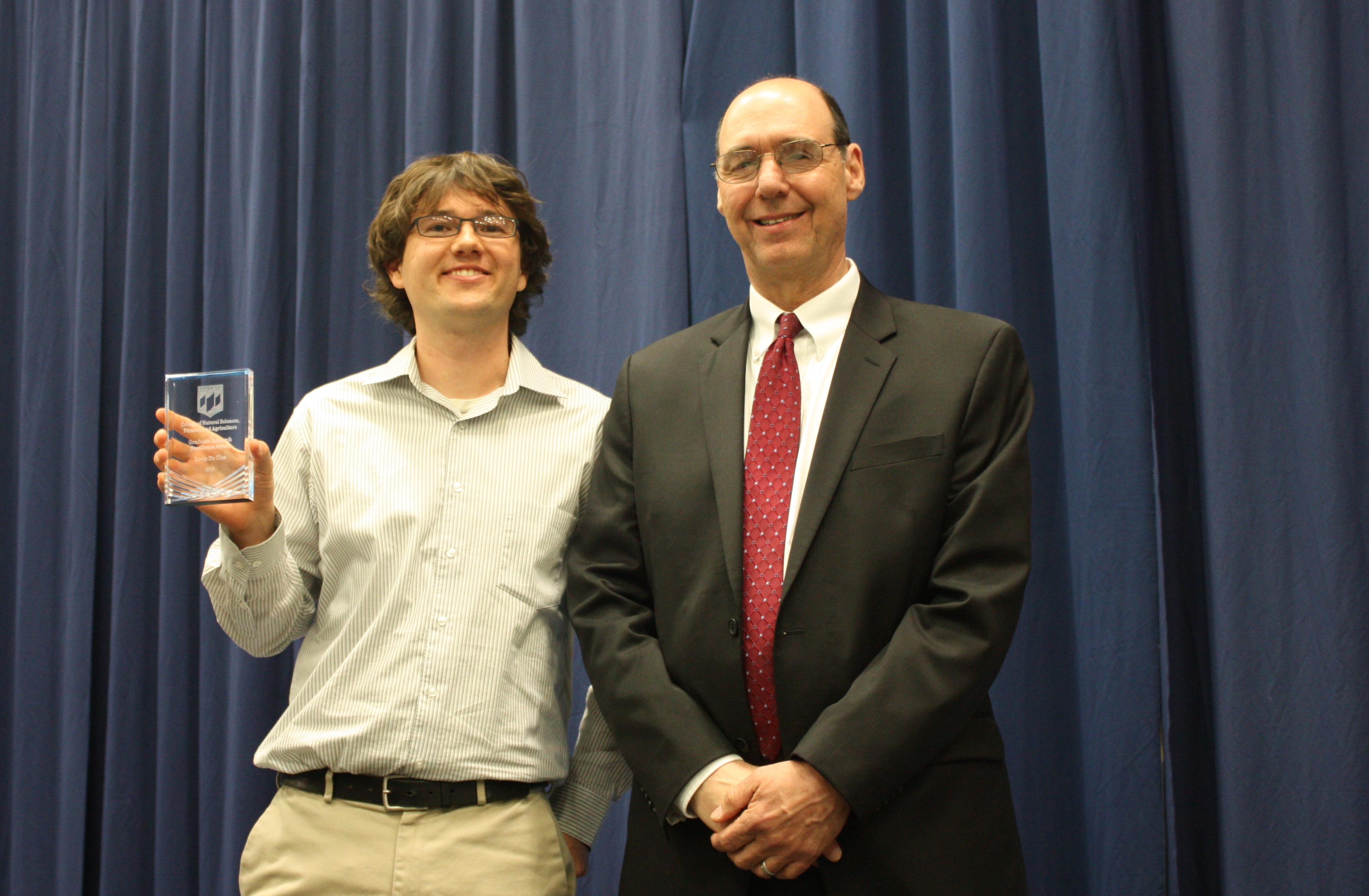 Picture of Kevin w/ award