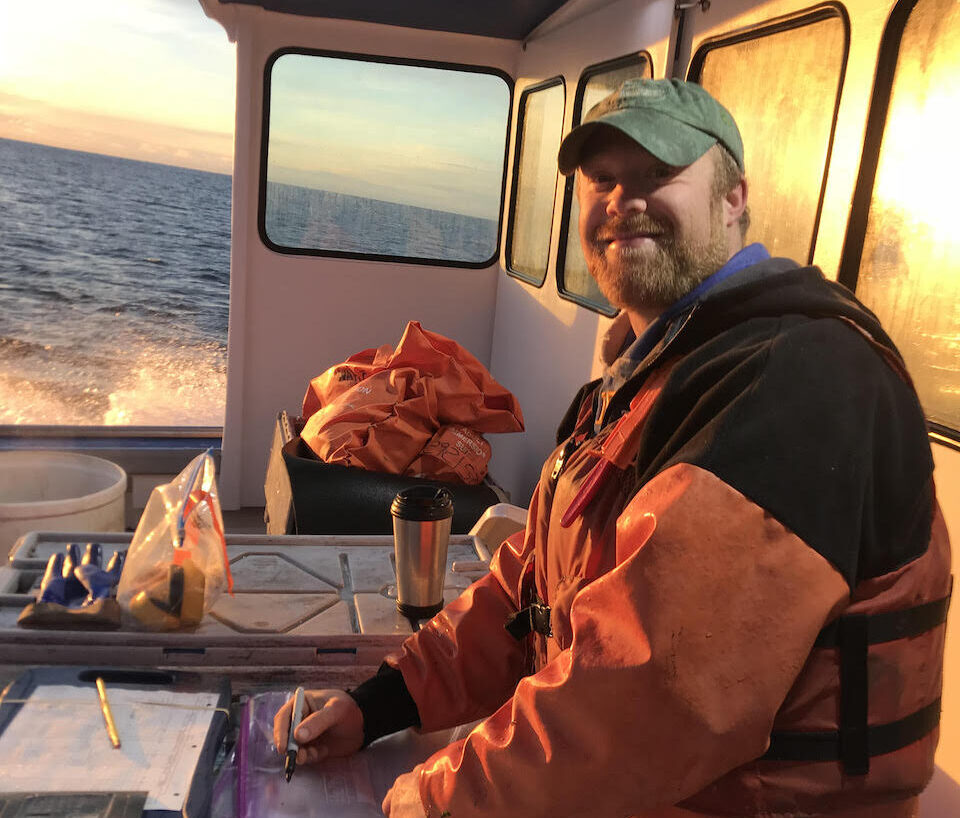 man records data on boat